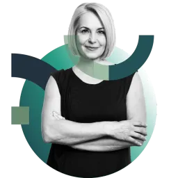 A smiling blonde woman with folded arms